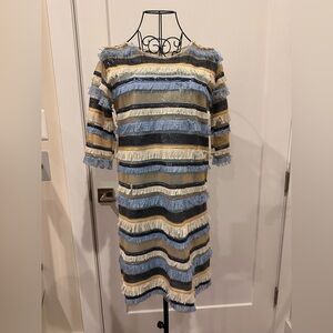 “Sequined, fringed, long-sleeve dress with an inner strappy layer.”